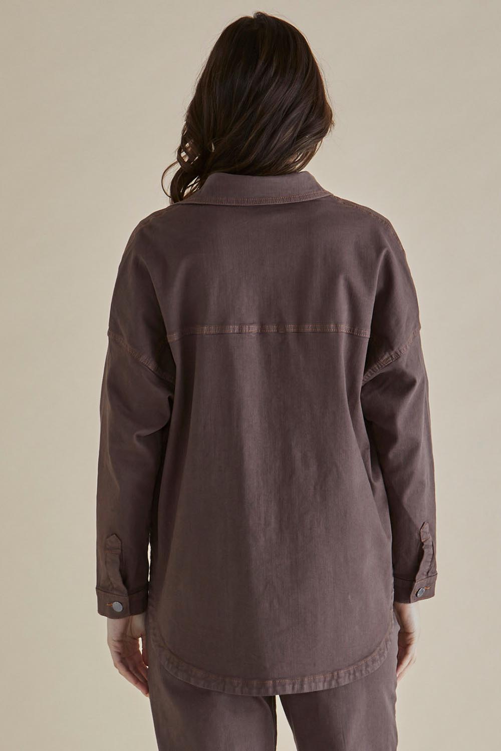 A model wearing the Cherry Denim Shirt in colour Coco, from the back