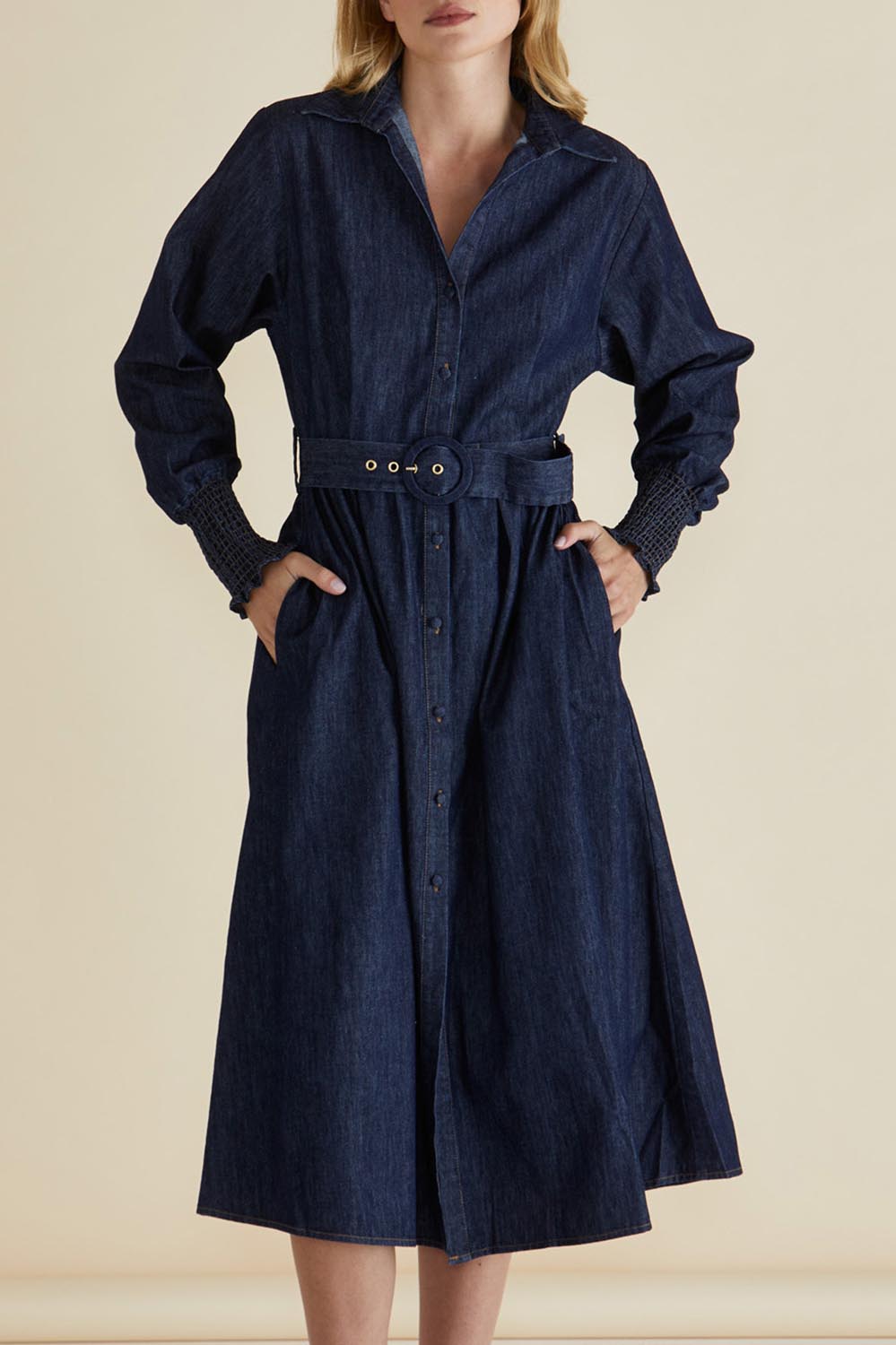 A model wearing the Denmark Denim Dress in colour Darkink (Blue), from the front, cropped image