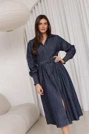 A model wearing the Denmark Denim Dress in colour Darkink (Blue), from the front, showing the whole outfit