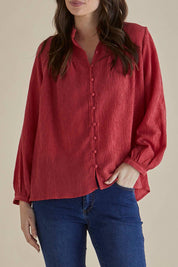 A model wearing the Marie Blouse in colour DustyPink (Pink), from the front, cropped image
