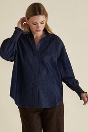 A model wearing the Sonderborg Denim Shirt in colour Darkink (Blue), from the front, cropped image