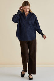 A model wearing the Sonderborg Denim Shirt in colour Darkink (Blue), from the front, showing the whole outfit