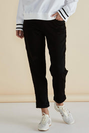 A model wearing the Harlow Denim Jogger in colour Blacklurex (Black), from the front, cropped image