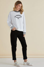 A model wearing the Harlow Denim Jogger in colour Blacklurex (Black), from the front, showing the whole outfit