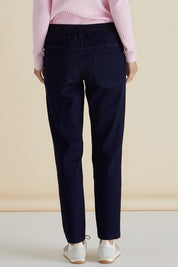 A model wearing the Harlow Denim Jogger in colour Indigo (Blue), from the back