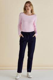 A model wearing the Harlow Denim Jogger in colour Indigo (Blue), from the front, showing the whole outfit