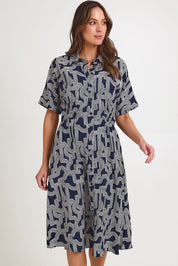 Model Madeline wearing size 10 of the Skye Dress in colour Navygeo (Blue), from the front, cropped image