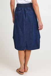 Model Madeline wearing size 10 of the Lizbeth Denim Skirt in colour Bluewash (Blue), from the back