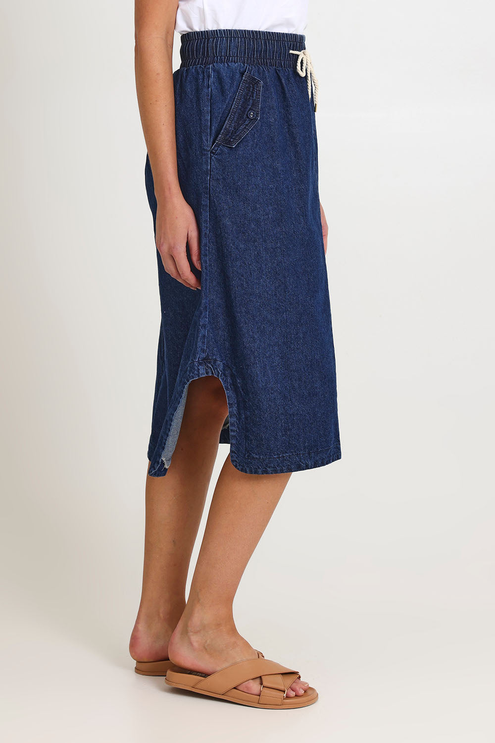 Model Madeline wearing size 10 of the Lizbeth Denim Skirt in colour Bluewash (Blue), from the front, cropped image