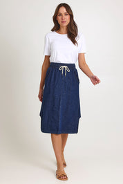 Model Madeline wearing size 10 of the Lizbeth Denim Skirt in colour Bluewash (Blue), from the front, showing the whole outfit