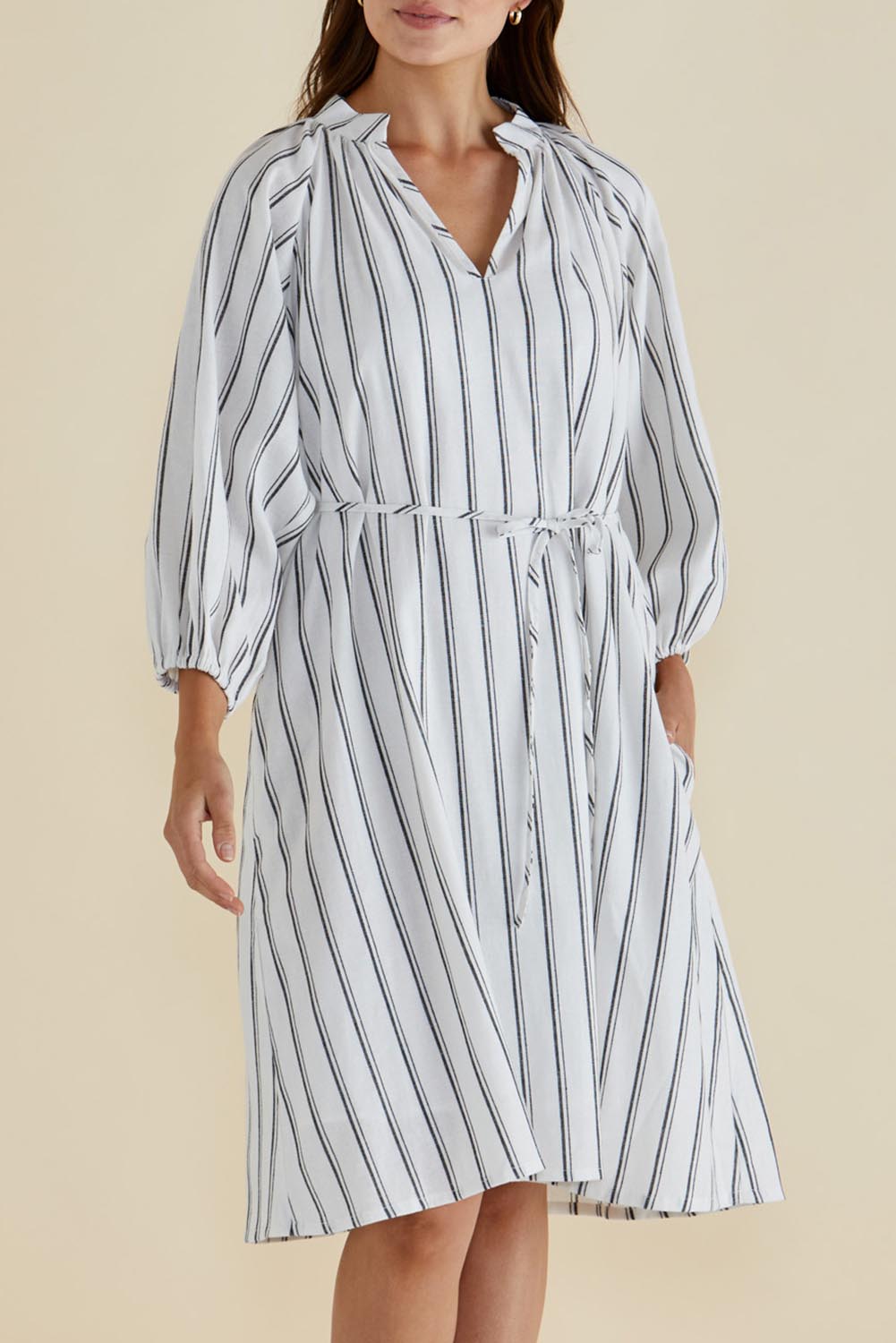 A model wearing the Jenna Dress in colour Blkwhite (White), from the front, cropped image