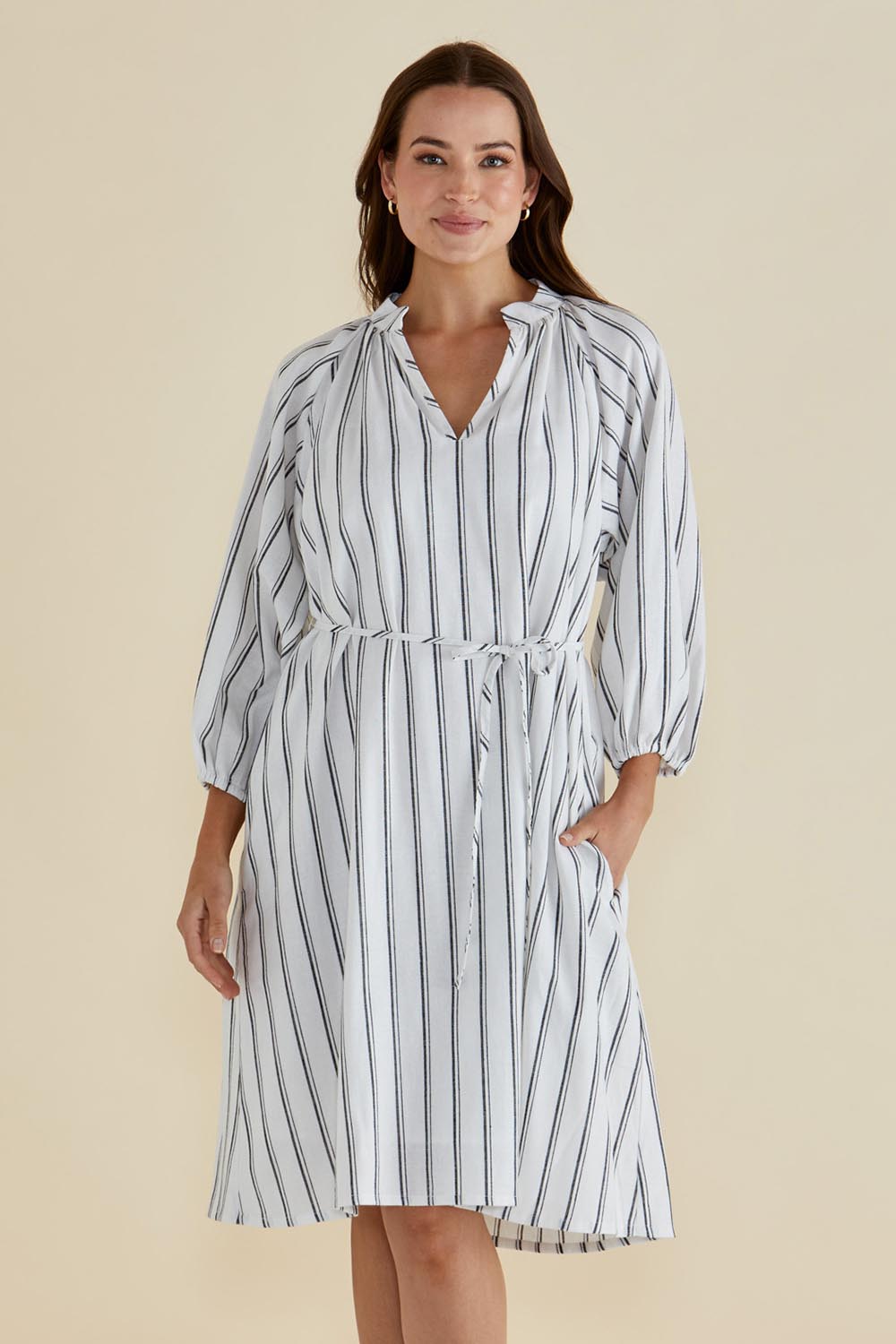 A model wearing the Jenna Dress in colour Blkwhite (White), from the front, cropped image