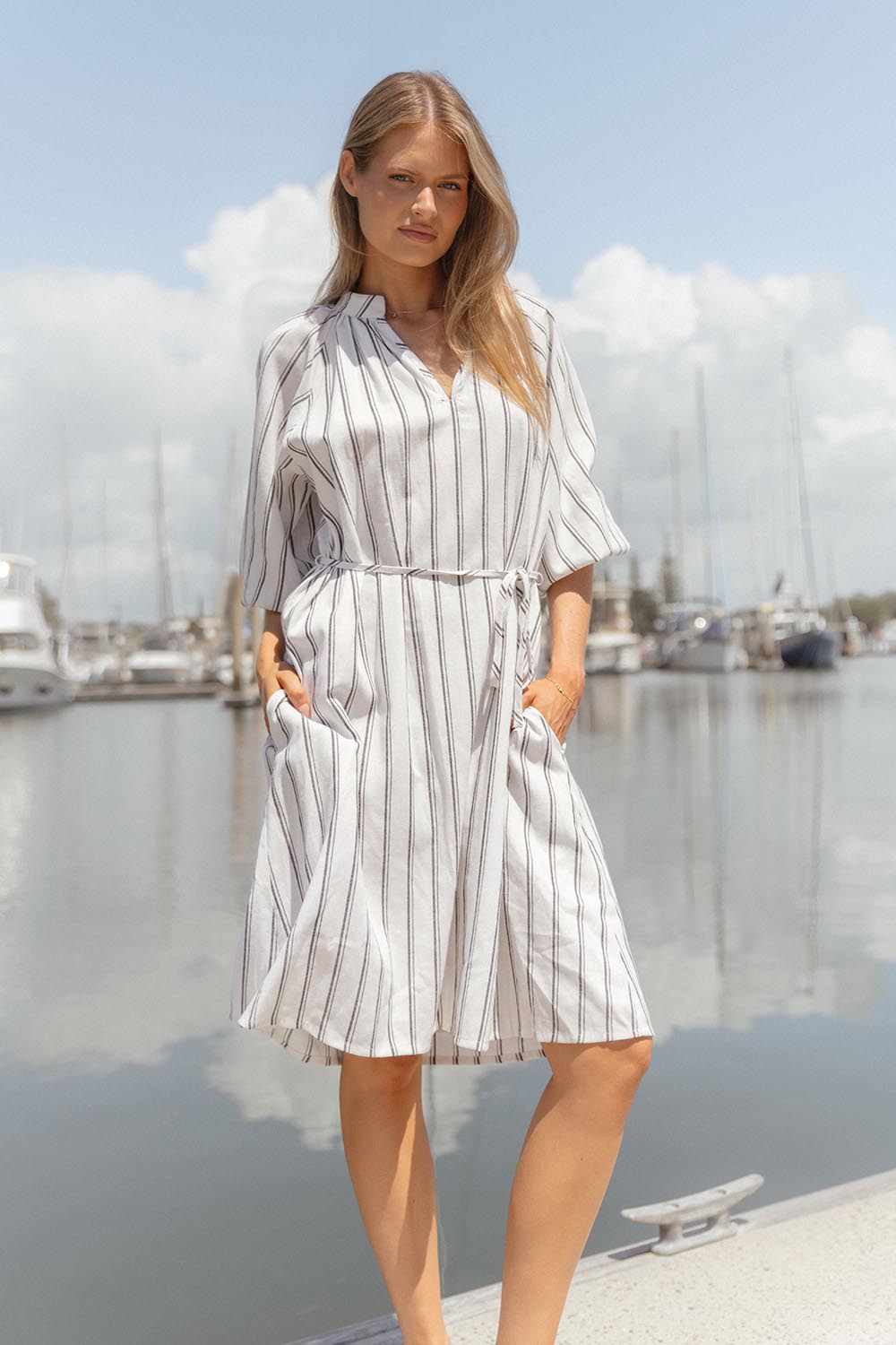 A model wearing the Jenna Dress in colour Blkwhite (White), from the front, showing the whole outfit