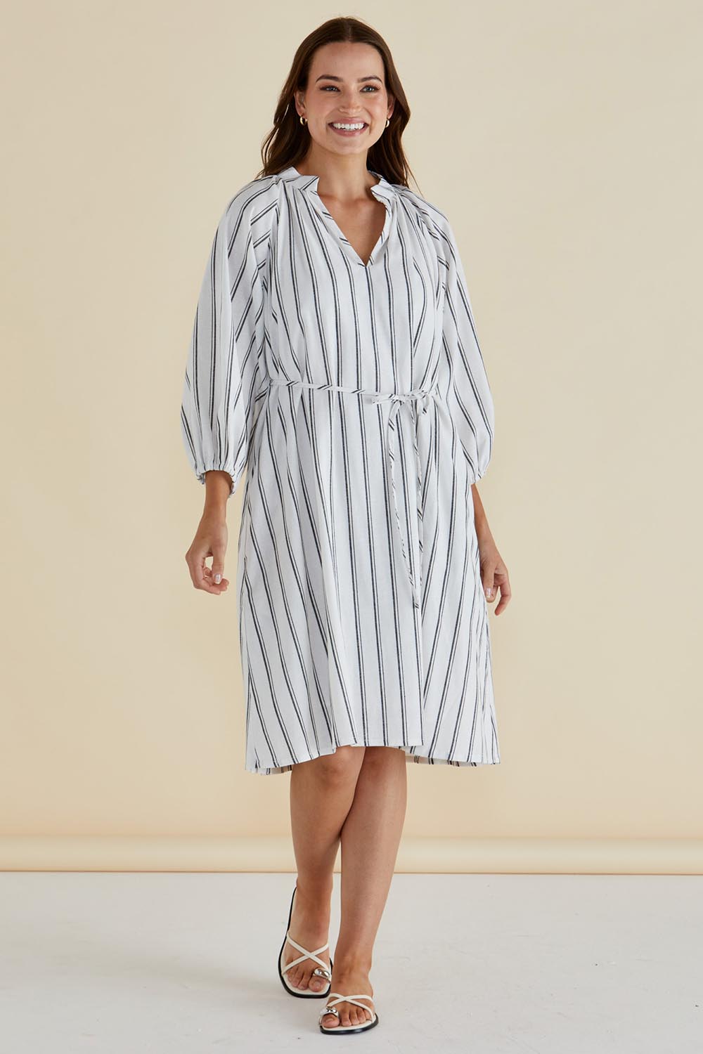 A model wearing the Jenna Dress in colour Blkwhite (White), from the front, showing the whole outfit