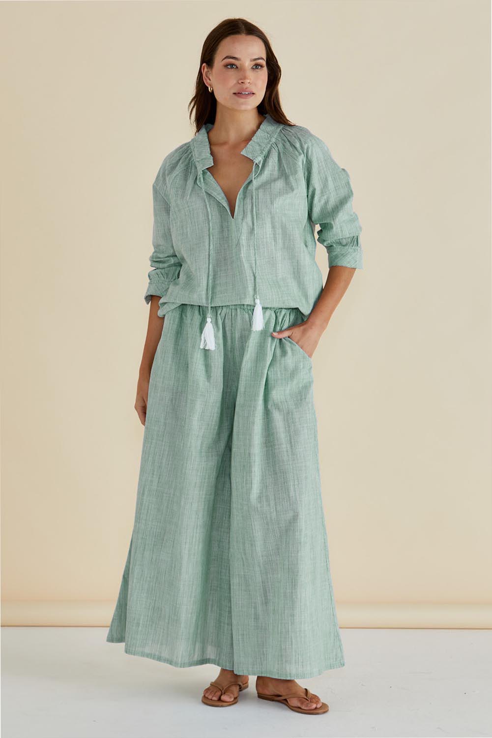 A model wearing the Tatum Cotton Wide Leg Pant in colour Green (Green), from the front, showing the whole outfit
