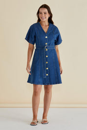 A model wearing the Fiori Denim Dress in colour Midwash (Blue), from the front, showing the whole outfit