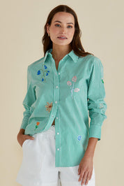 A model wearing the Kimmie Floral Cotton Shirt in colour Green (Green), from the front, cropped image