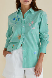 A model wearing the Kimmie Floral Cotton Shirt in colour Green (Green), from the front, cropped image