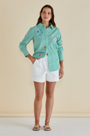 A model wearing the Kimmie Floral Cotton Shirt in colour Green (Green), from the front, showing the whole outfit