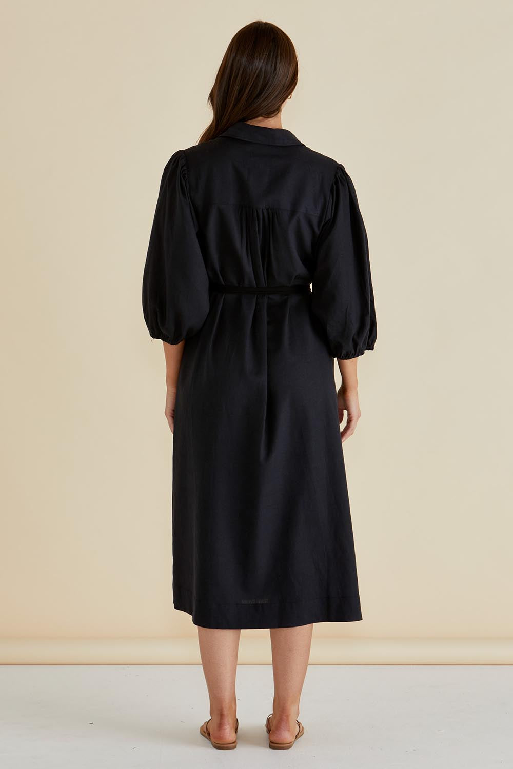 A model wearing the Angelina Linen Blend Dress in colour Black (Black), from the back
