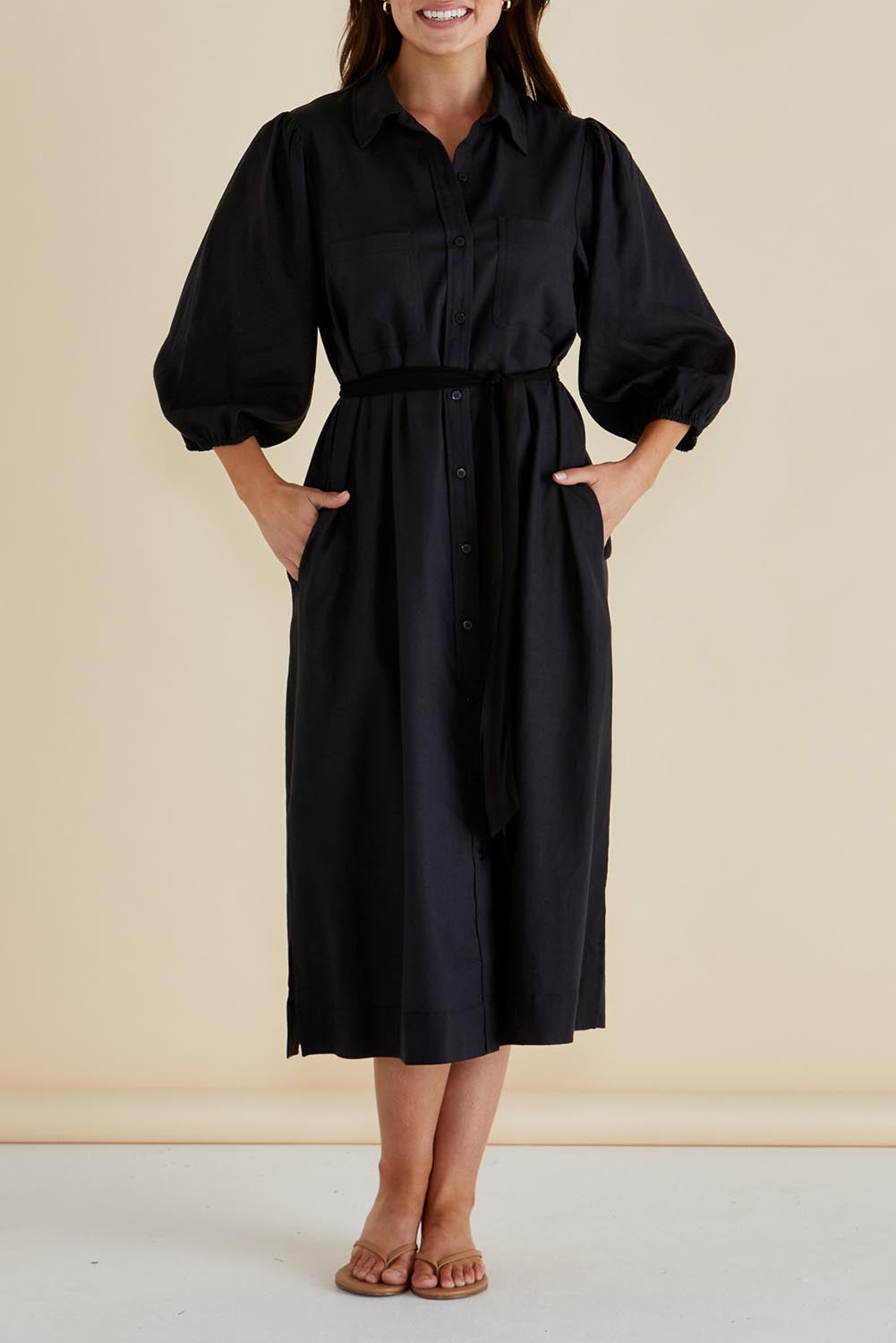 A model wearing the Angelina Linen Blend Dress in colour Black (Black), from the front, cropped image