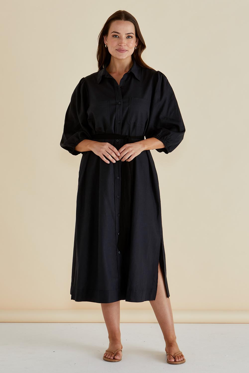 A model wearing the Angelina Linen Blend Dress in colour Black (Black), from the front, showing the whole outfit