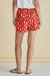 A model wearing the Copacabana Short in colour Sardinia (Red), from the back