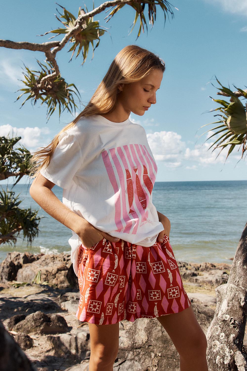 A model wearing the Copacabana Short in colour Sardinia (Red), from the front, showing the whole outfit