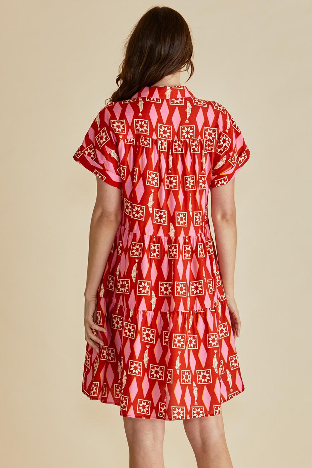 A model wearing the Copacabana Shirt Dress in colour Sardinia (Red), from the back