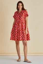 A model wearing the Copacabana Shirt Dress in colour Sardinia (Red), from the front, showing the whole outfit