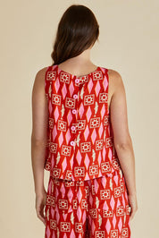 A model wearing the Copacabana Shell Top in colour Sardinia (Red), from the back