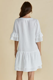A model wearing the Malibu Cotton Dress in colour White (White), from the back