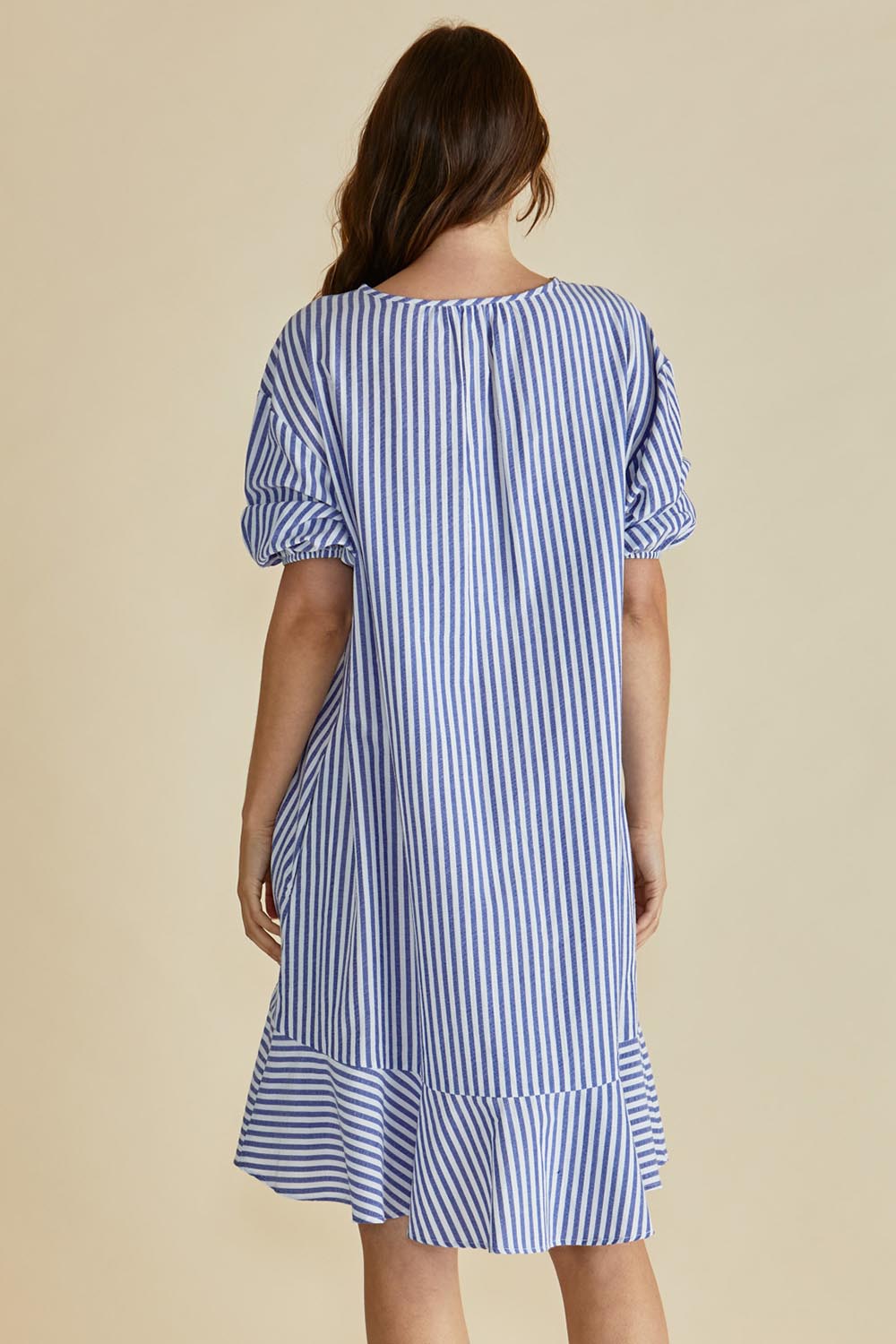 A model wearing the Livvy Cotton Blend Dress in colour Navystripe (Blue), from the back