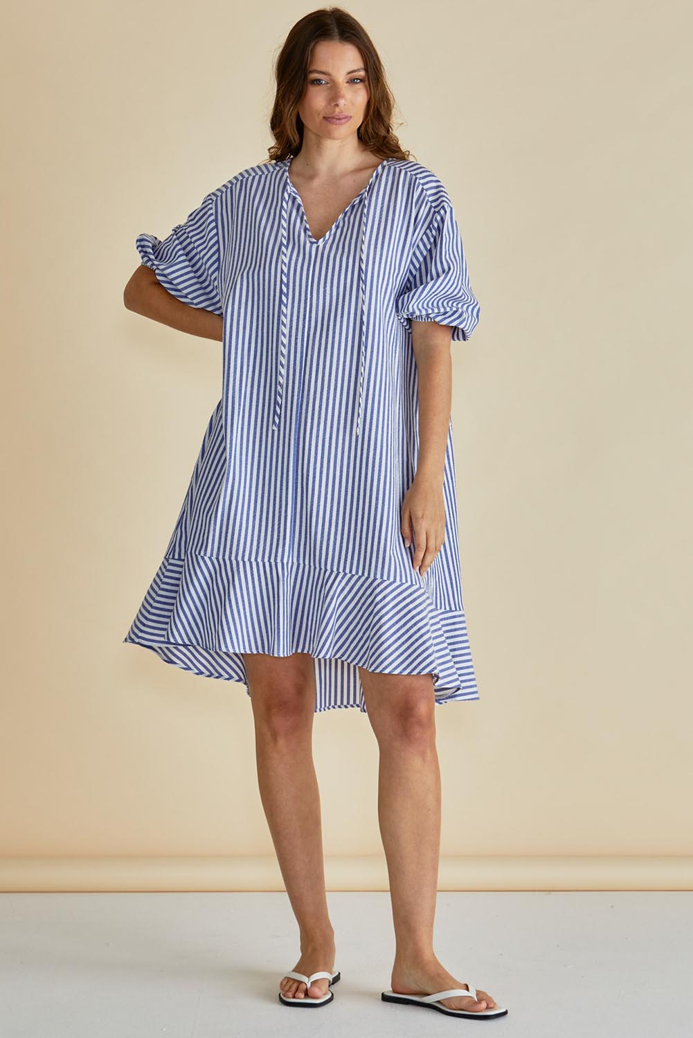 A model wearing the Livvy Cotton Blend Dress in colour Navystripe (Blue), from the front, showing the whole outfit