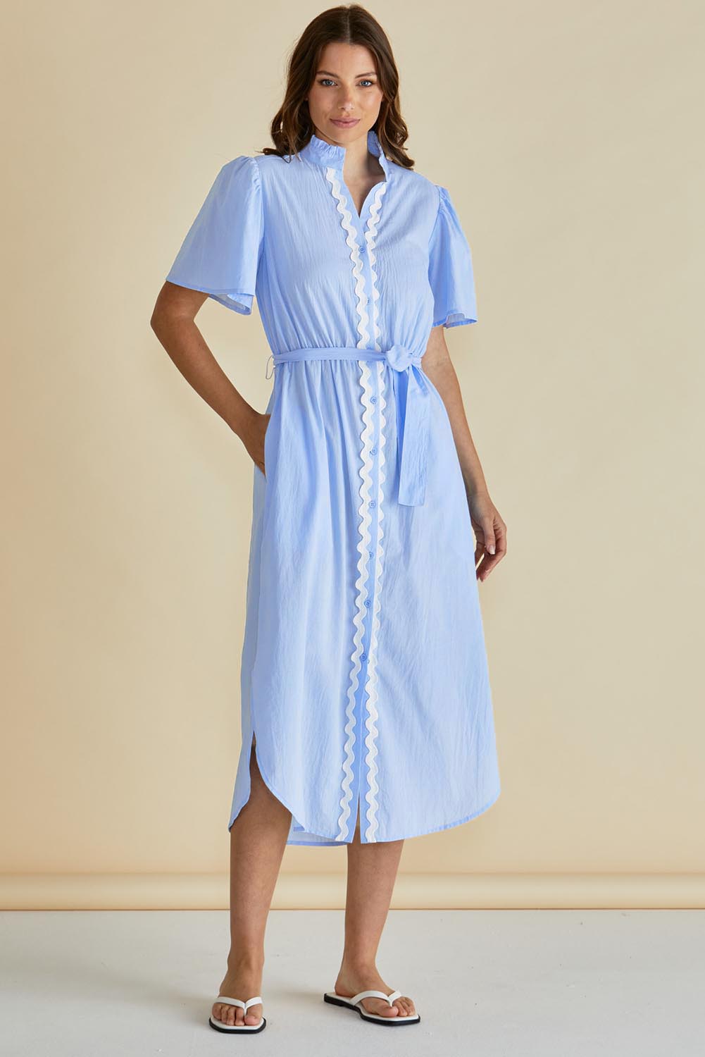 A model wearing the Immie Cotton Dress in colour Bluericrac (Blue), from the front, showing the whole outfit