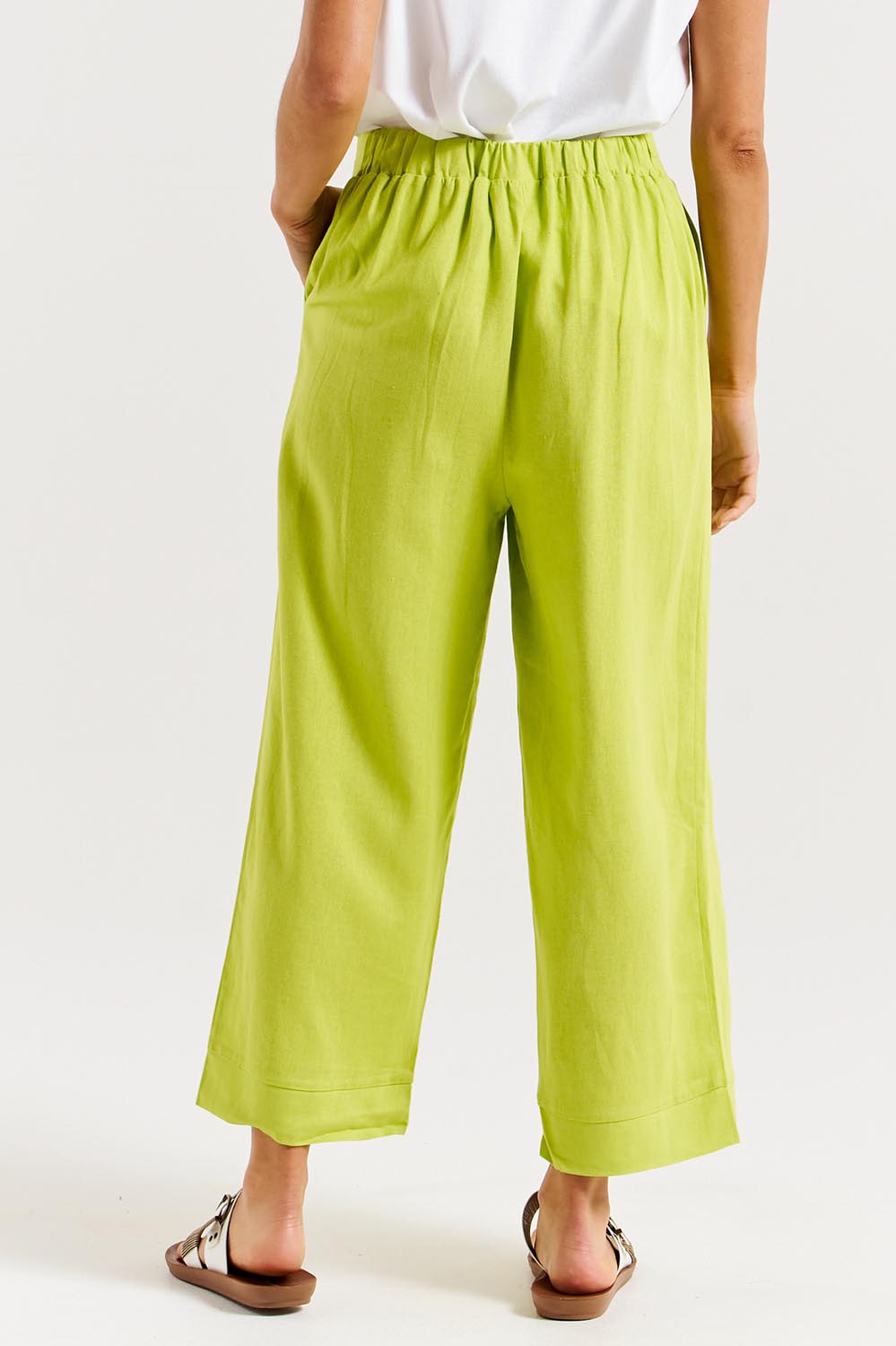 A model wearing the Parker Pant in colour Limegreen (Green), from the back