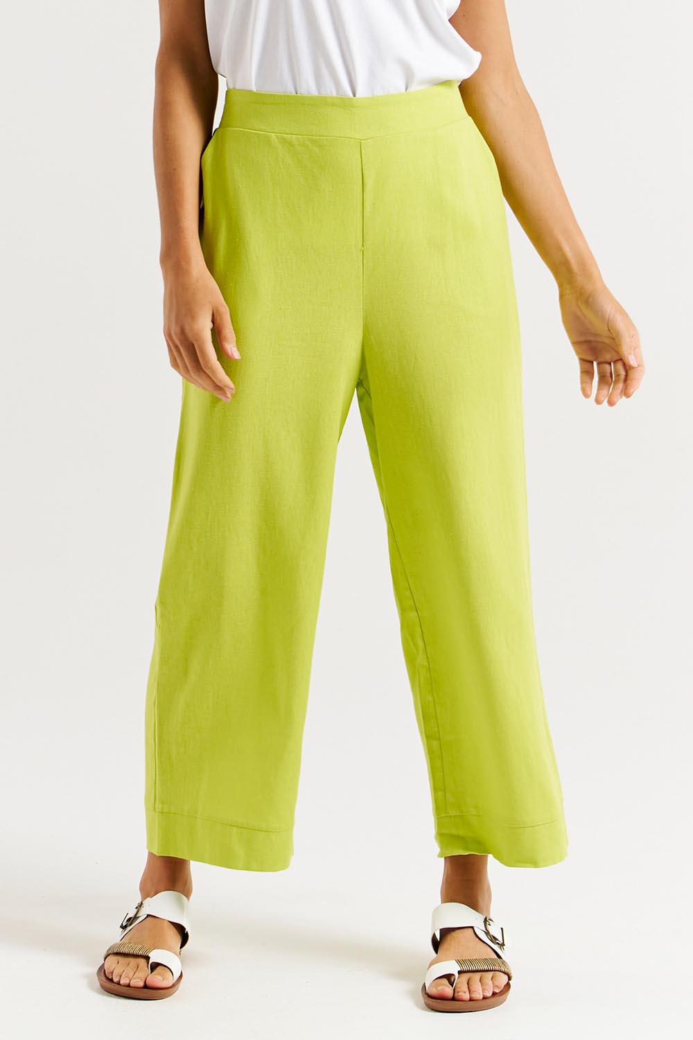 A model wearing the Parker Pant in colour Limegreen (Green), from the front, cropped image