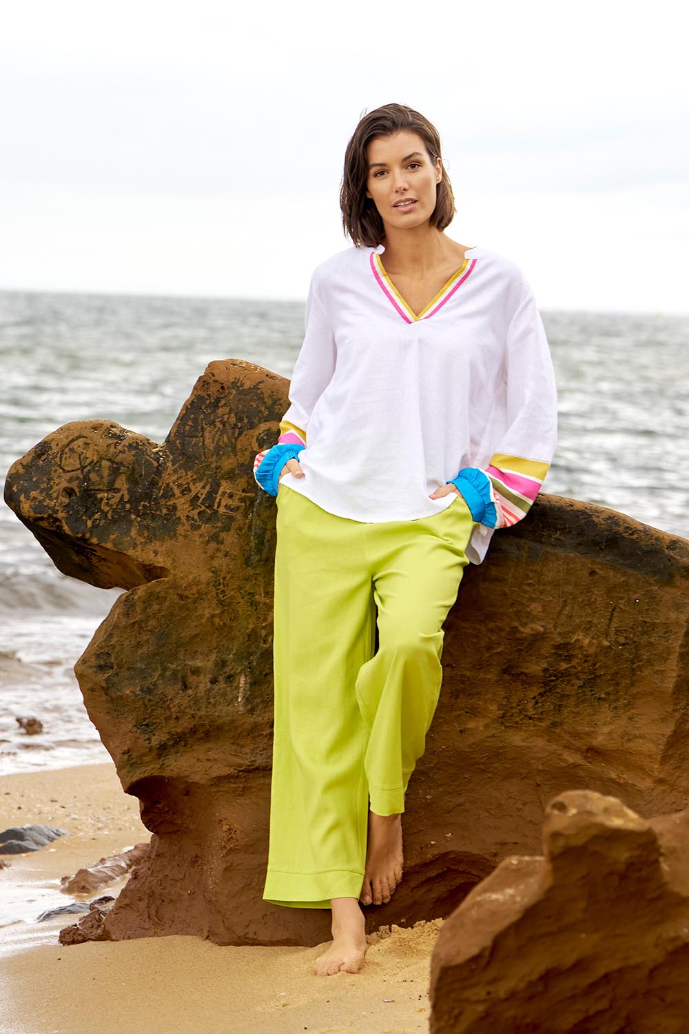 A model wearing the Parker Pant in colour Limegreen (Green), from the front, showing the whole outfit