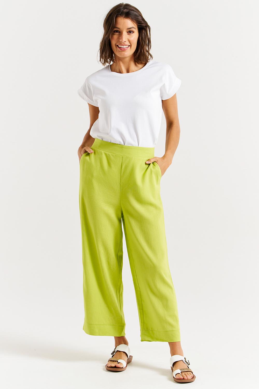 A model wearing the Parker Pant in colour Limegreen (Green), from the front, showing the whole outfit
