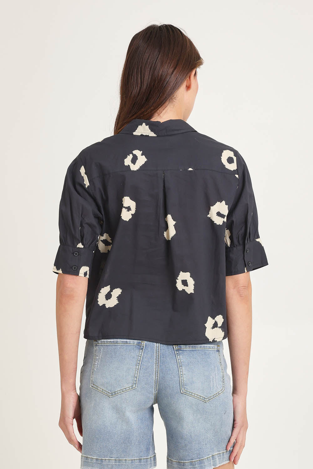Model Madeline wearing size 10 of the Reagan Cotton Poplin Shirt in colour Leopard (Black), from the back