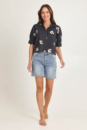 Model Madeline wearing size 10 of the Reagan Cotton Poplin Shirt in colour Leopard (Black), from the front, showing the whole outfit