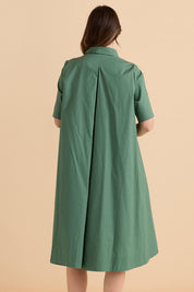 A model wearing the Savannah Cotton Swing Shirt Dress in colour Green (Green), from the back