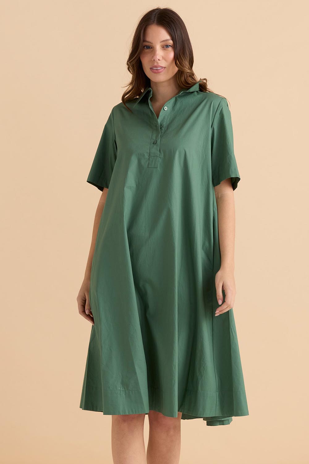 A model wearing the Savannah Cotton Swing Shirt Dress in colour Green (Green), from the front, cropped image