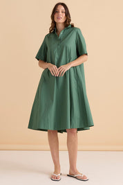 A model wearing the Savannah Cotton Swing Shirt Dress in colour Green (Green), from the front, showing the whole outfit