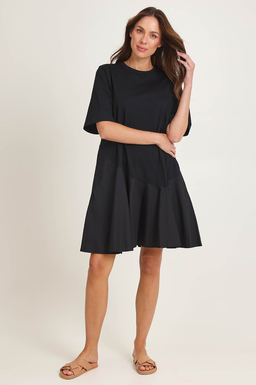 Model Madeline wearing size 10 of the Cassidy Cotton Dress in colour Black (Black), from the front, showing the whole outfit
