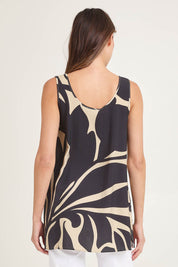 Model Madeline wearing size 10 of the Lana Tunic Tank in colour Floral (Black), from the back