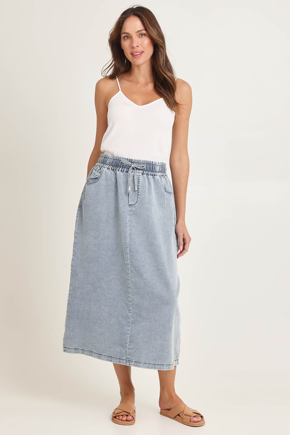 Model Madeline wearing size 10 of the Denim Maxi Jogger Skirt in colour Lightblue (Blue), from the front, showing the whole outfit