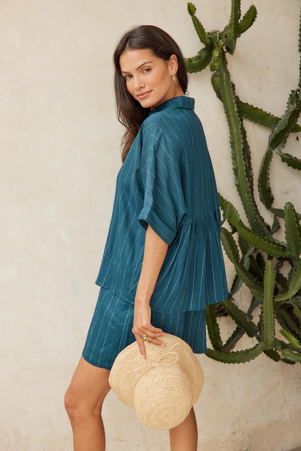 Model Genericm wearing size sample of the Ophelia Shirt – Teal in colour Teal, from an angle