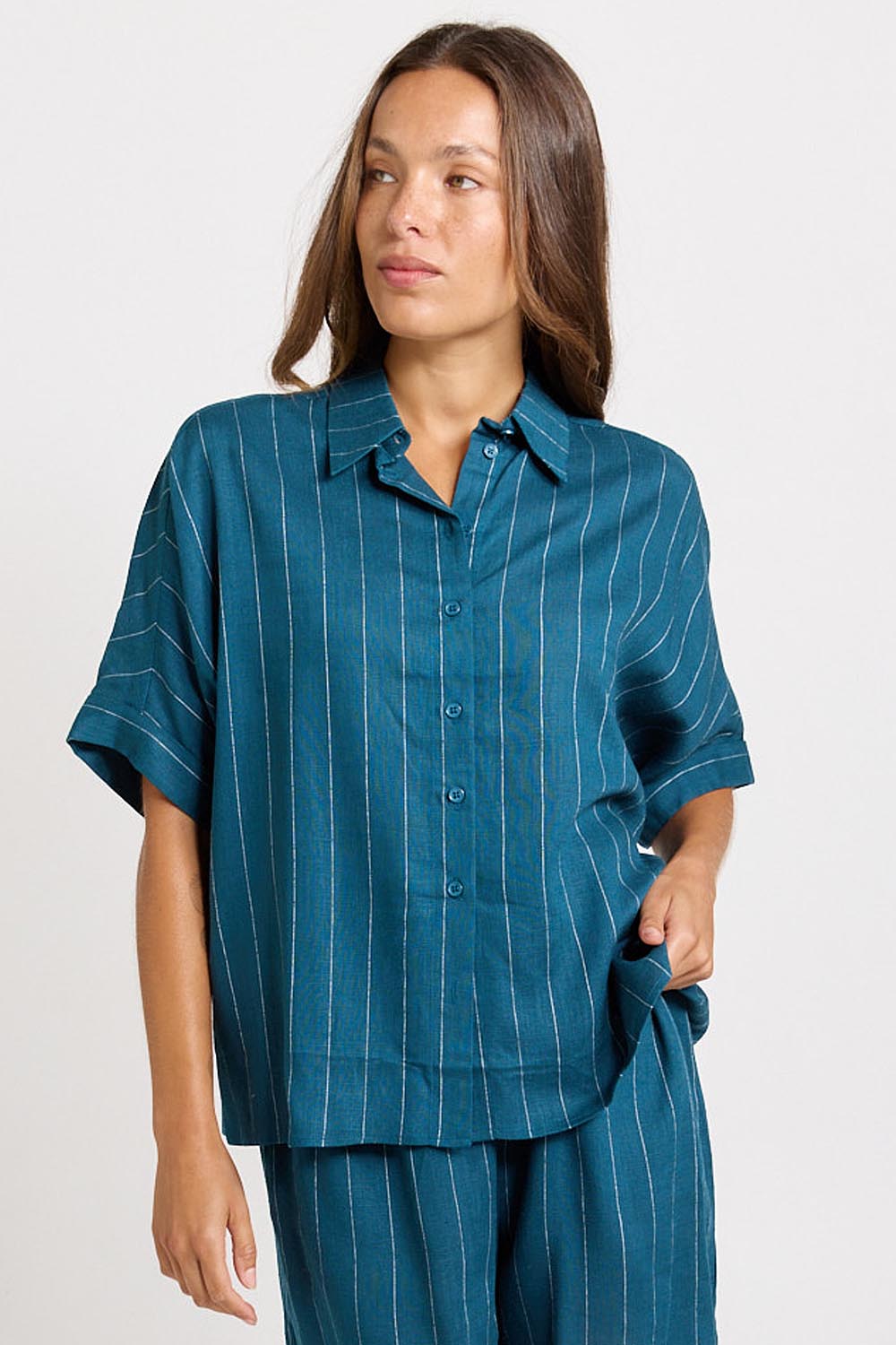 Model Genericm wearing size sample of the Ophelia Shirt – Teal in colour Teal, in a cropped view