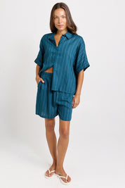 Model Genericm wearing size sample of the Palm Relax Shorts – Teal in colour Teal, from the front